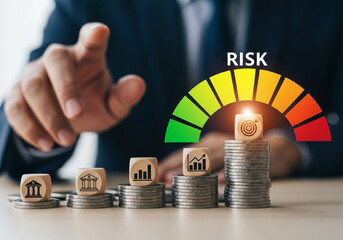 Businessman pointing towards a risk meter with increasing levels over stacks of coins and wooden blocks