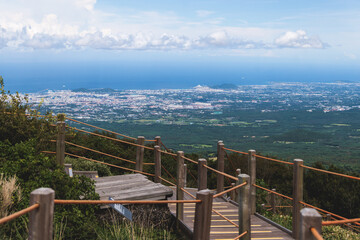 Obraz premium Hallasan National Park, Jeju island, South Korea, vibrant view of trail with a wooden ladder path stairs, trekking and climbing, stairway to Halla mountain summit, hiking in Korea, Jeju-do, sunny day