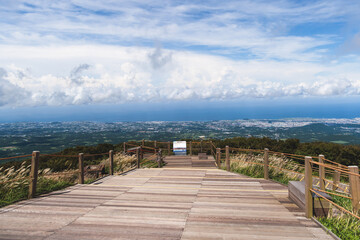 Obraz premium Hallasan National Park, Jeju island, South Korea, vibrant view of trail with a wooden ladder path stairs, trekking and climbing, stairway to Halla mountain summit, hiking in Korea, Jeju-do, sunny day