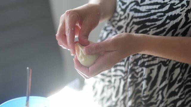 Preparing homemade dumplings with fresh ingredients in a cozy kitchen