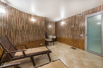 Recreation room in the wellness center. Beautiful wall decor. Wooden chairs.