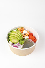 Fresh avocado salad bowl with chicken and greens