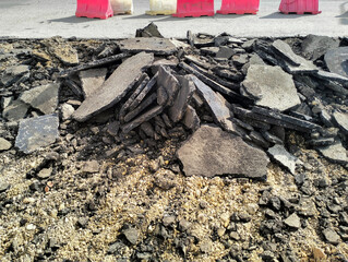 Broken pieces of asphalt at a construction site. Recycling and reuse crushed concrete rubble