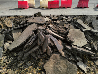 Broken pieces of asphalt at a construction site. Recycling and reuse crushed concrete rubble
