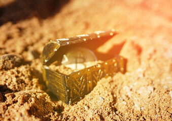 Bitcoin Treasure Chest. Treasure chest gold coin shiny Bitcoin buried in sand. BTC Crypto mining...
