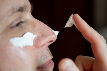 Eye Cream for Man, close-up of mans eye smear of eye cream under the eye	
