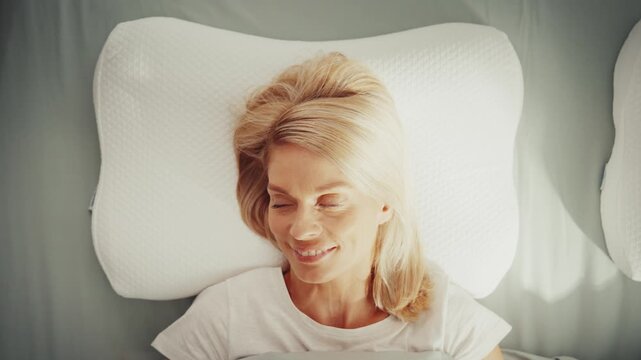 Peaceful woman resting on ergonomic memory foam pillow
