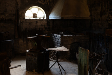A reconstruction of a medieval forge blacksmith with tools.