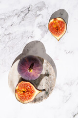 Ripe fig fruits whole and cut open on plate.