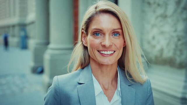 Smiling Businesswoman Standing Outdoors in Modern City Street