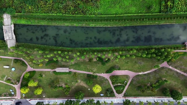 Aerial Sideways View of Park Path and River Bridge