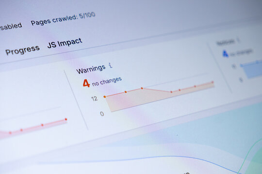 Close-up of a digital dashboard displaying website analytics, showing Pages crawled: 5100, JS Impact, and Warnings 4 no changes, crucial for web optimization