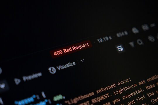 Computer screen shows 400 Bad Request error, programming code, symbolizing web development issue, network failure, and complex debugging task