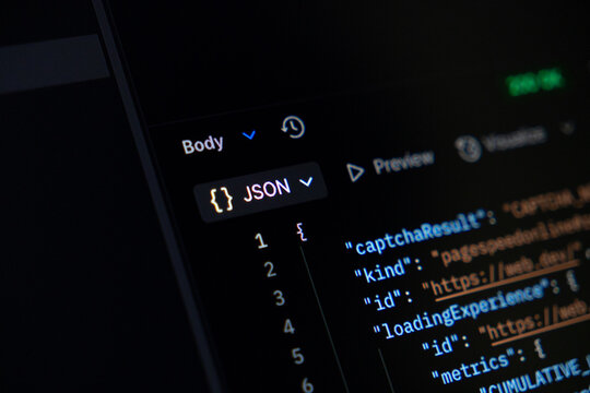 JSON programming code visible on a dark computer screen, illustrating data exchange protocols fundamental for modern web development and backend applications