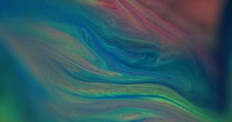 Blur color water. Paint flow. Defocused yellow blue pink chemical liquid sparkling shimmer pigment floating on abstract background.