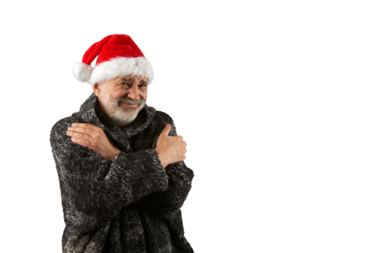 A portrait of a senior citizen wearing a fur coat and Santa Claus hat, his face miserable from the cold. He tries to keep warm by hugging himself. Png .
