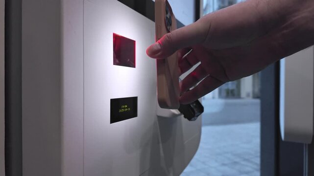 Customer's hand using a smartphone to scan an automated parcel locker display showing 2023-09-11, enabling quick contactless pickup