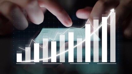 A business professional uses a smartphone to analyze data trends, showcasing growth through digital...