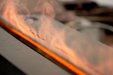 Close-up of a Modern Bioethanol Fireplace with Warm, Orange Flames and Smoke