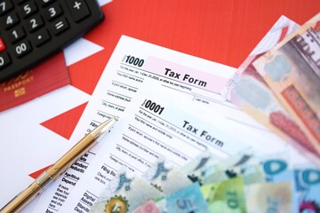 Bahraini dinar money bills and calculator with tax form on flag. Taxation and accounting concept