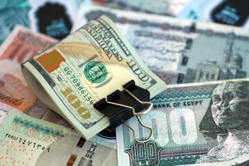 Egyptian pound currency money bills and bunch of us dollars. The concept of currency exchange