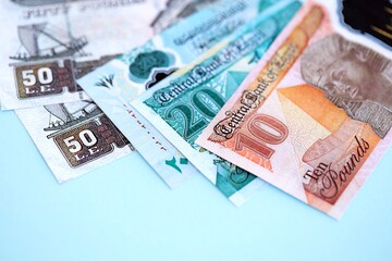 Egyptian pound money bills in big amount on blue. Finance and banking concept