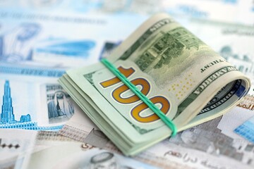 United Arab Emirates dirham currency money bills and bunch of us dollar banknotes. The concept of economics and currency exchange