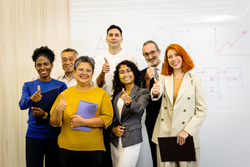 Portrait group of diverse businesspeople standing together. Happy successful business staff standing with multiethnic coworkers giving thumbs up. Smiling confident business team in office company.