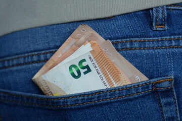 Stack of €50 Euro Banknotes Tucked into the Back Pocket of Blue Jeans, Representing Hidden Wealth, Savings, and Financial Readiness