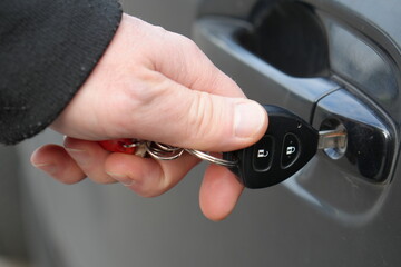 Hand Inserting Car Key into Door Lock