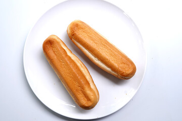 Two hot dog buns bottom side on white plate. food