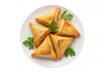 Golden triangular pastries with green garnish isolated on a transparent background