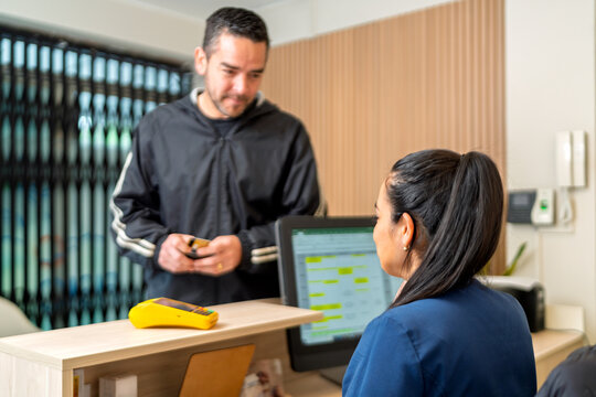 Client checking in at physical therapy center reception