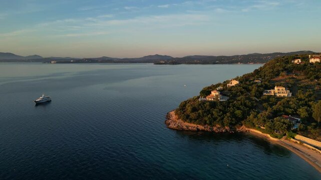 Barbati Beach. Scenic coastal view transitions from serene waters to lush greenery, capturing the tranquil beauty of a beachside resort with gentle waves and distant hills