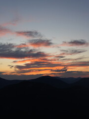 Peaceful night in the mountains — campfire, tents and starry sky