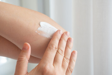 Cream on elbow skin. Applying the lotion to dry rough hands skin, elbow moisturizing creme
