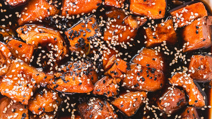 Delicious sticky pork chunks glistening with soy-honey tare glaze. Generously coated in sweet-savory sauce and topped with sesame seeds, served sizzling in an elegant serving dish.