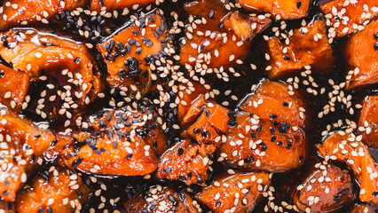 Delicious sticky pork chunks glistening with soy-honey tare glaze. Generously coated in sweet-savory sauce and topped with sesame seeds, served sizzling in an elegant serving dish.