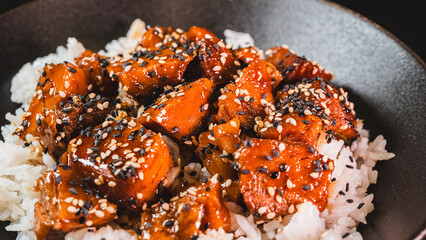 A beautiful bowl featuring sticky soy-honey glazed pork over fluffy oriental rice. Topped with sesame seeds and scallions, this delicious bowl combines sweet and savory flavors perfectly.