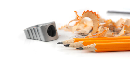 Sharpening pencils. Yellow wooden graphite pencils with erasers, pencil shavings