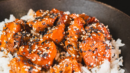 A beautiful bowl featuring sticky soy-honey glazed pork over fluffy oriental rice. Topped with sesame seeds and scallions, this delicious bowl combines sweet and savory flavors perfectly.