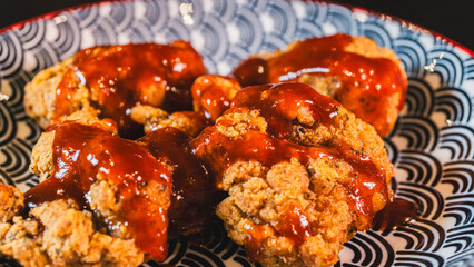 Sizzling Korean fried chicken coated in glossy red gochujang sauce. Extra crispy chicken pieces glistening with sweet-spicy glaze, garnished with sesame seeds and scallions.