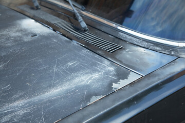 Old car with damaged paint. Close up view