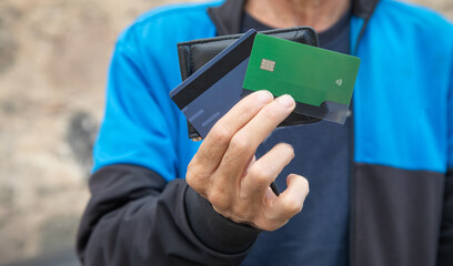 Caucasian man showing wallet with a credit card.