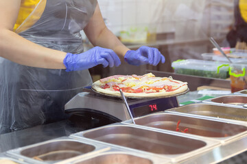 Making delicious pizza at a pizzeria