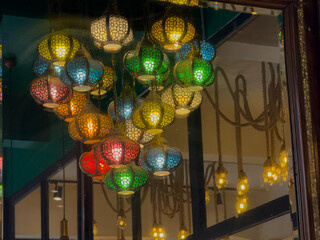 Decorative colorful lanterns in an artistic arrangement reflecting in a mirror creating elegance