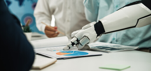 A robotic arm points at colorful charts and graphs, highlighting the fusion of technology and human...