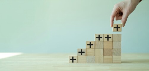 Building Positive Progress: A hand strategically places a wooden block, symbolizing the act of fostering growth and reinforcing positive values within an innovative approach.