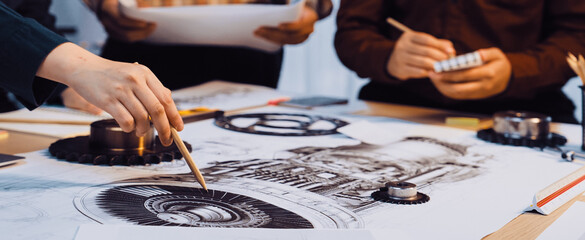 Engineers engage in a dynamic discussion over intricate technical drawings in a collaborative workspace, illustrating creativity and teamwork in project development. SACTR