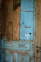 an old blue wooden door in an abandoned house